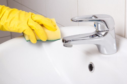 Local office cleaners in Bromley vacuuming carpets and sanitising desks